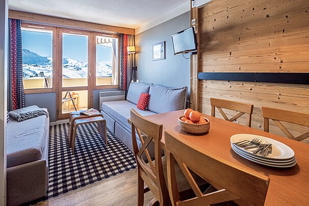 A living room with a couch and a table with plates on it