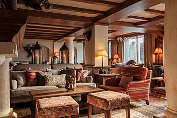 A living room with a couch and chairs and a table