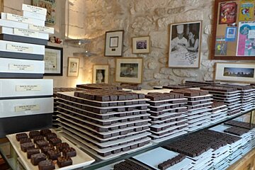A display of chocolates in a store with a sign that says ' coca cola ' on it
