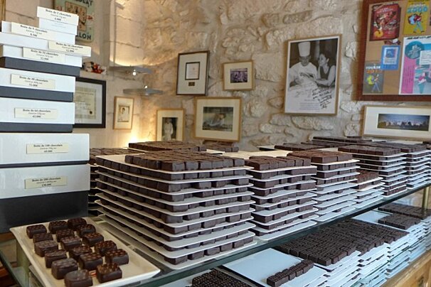 A display of chocolates in a store with a sign that says ' coca cola ' on it