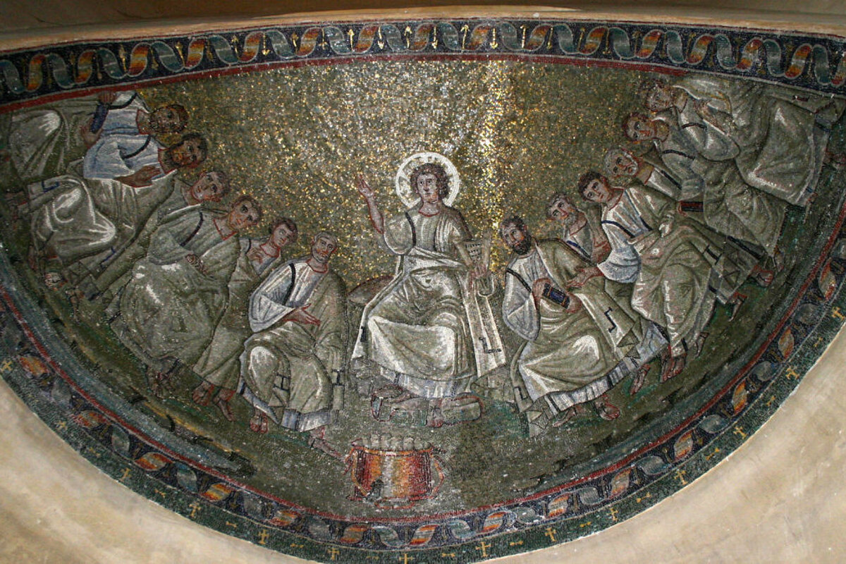A mosaic of jesus surrounded by a group of people with the word jesus on the bottom