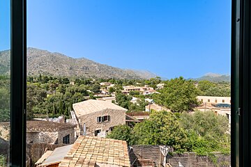 A view of a village with mountains in the background