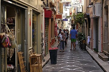 a narrow shopping street with many small craft shops