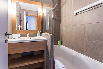 A bathroom with a bathtub and a sink
