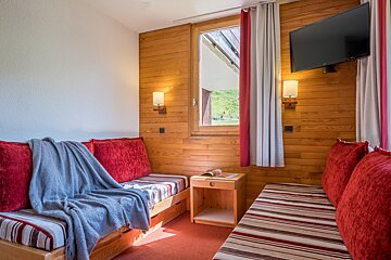 A living room with a couch and a flat screen tv
