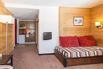 A living room with a couch and a picture on the wall