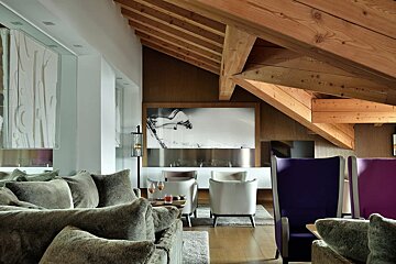 A living room with a couch and chairs and a picture on the wall