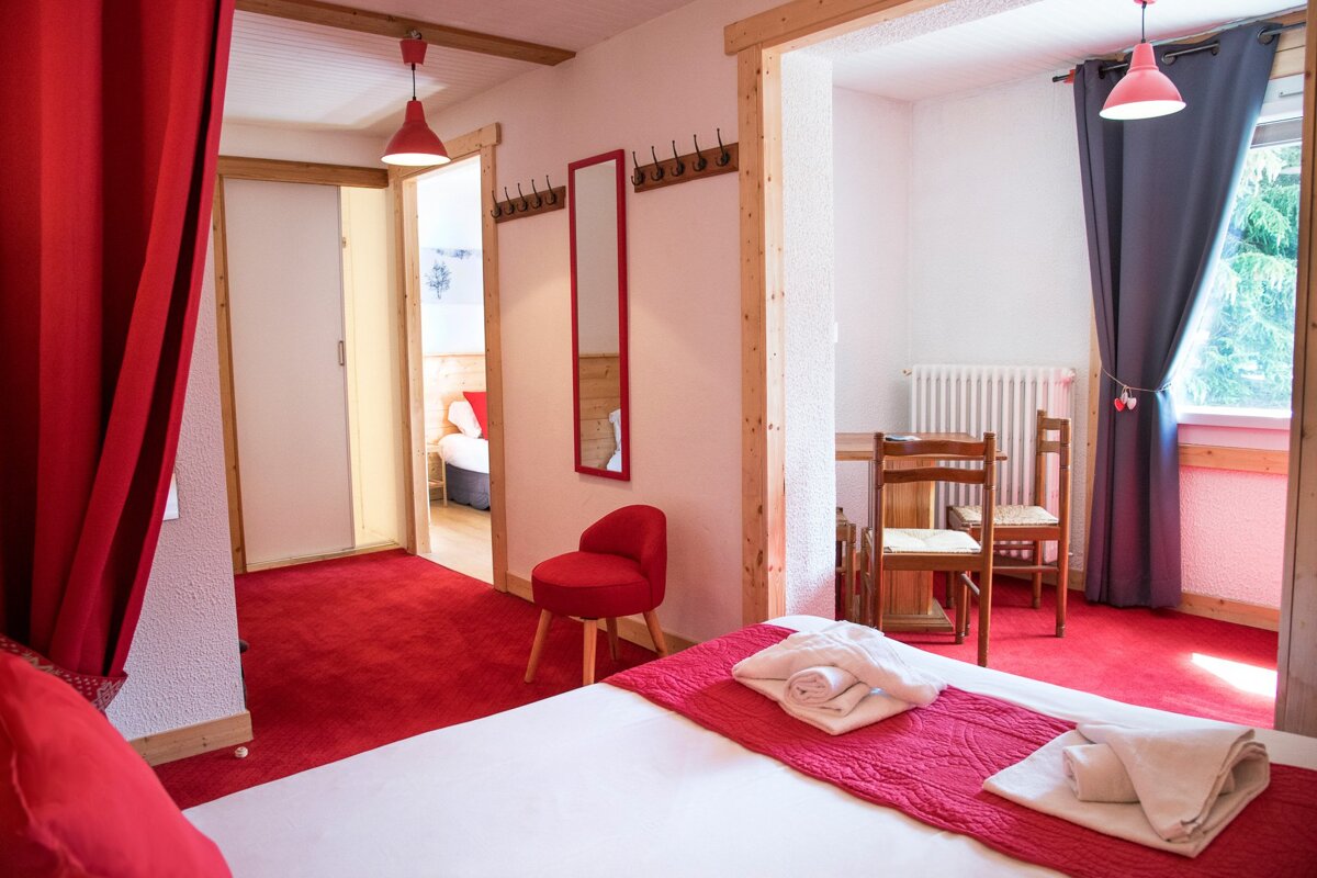 A bedroom with a bed a chair and a table