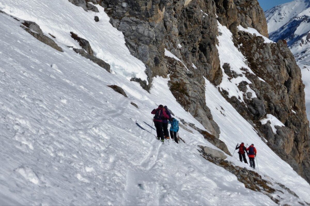 skiers traversing the mountain side