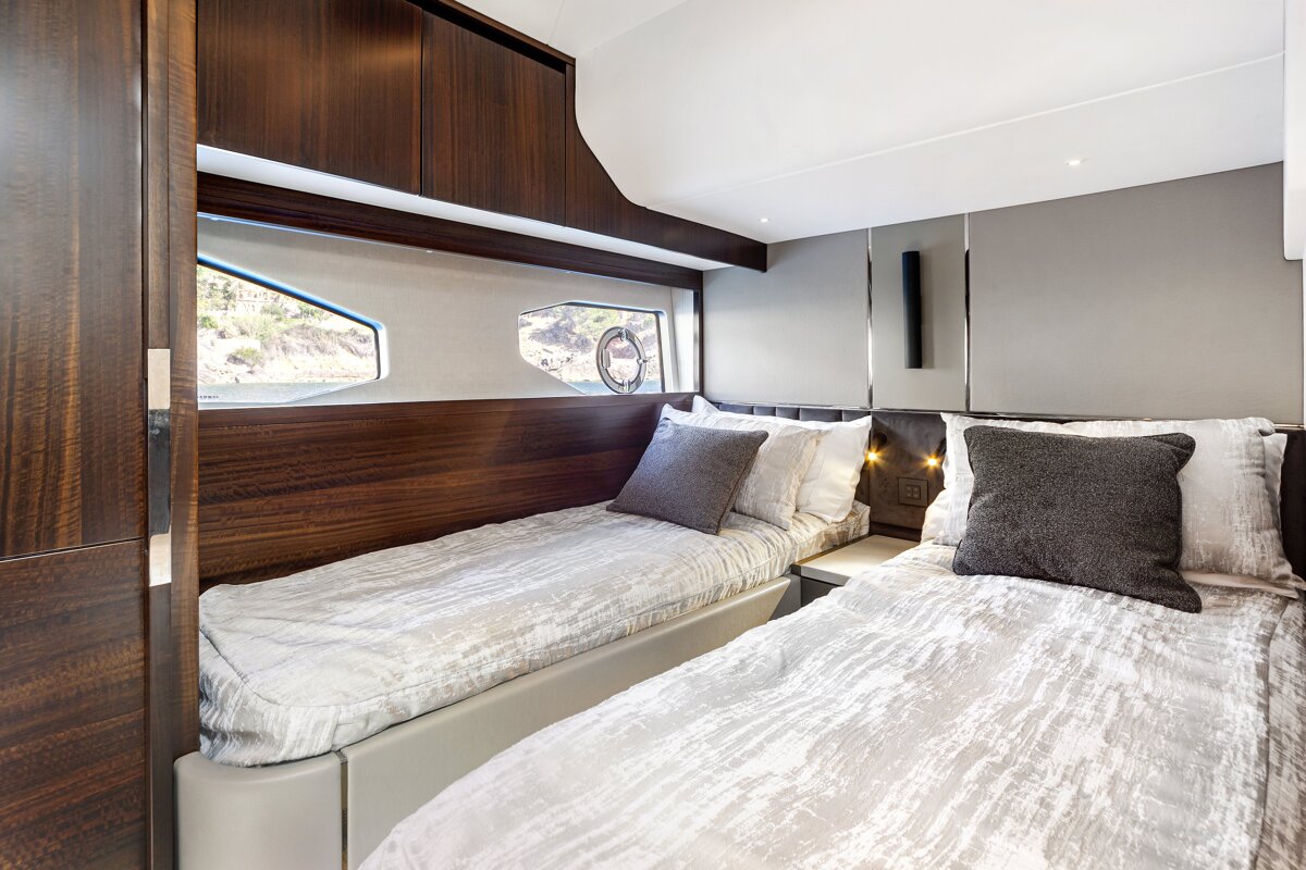 A bedroom with two beds and a window