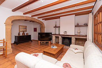 A living room with a fireplace and a flat screen tv