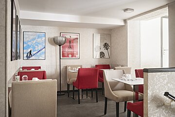 A room with tables and chairs and a poster that says cannes