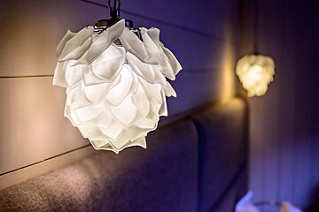 A light shaped like a flower is hanging from the ceiling