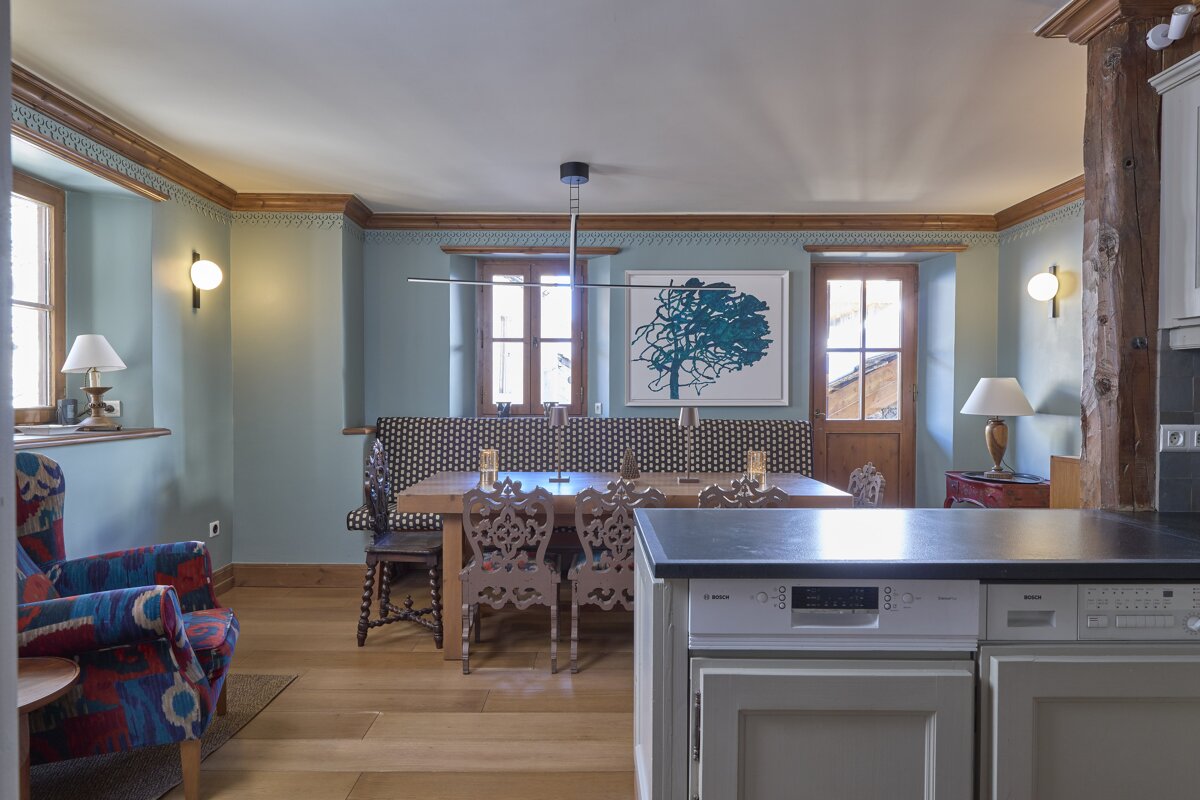 A kitchen with a bosch dishwasher and a table and chairs