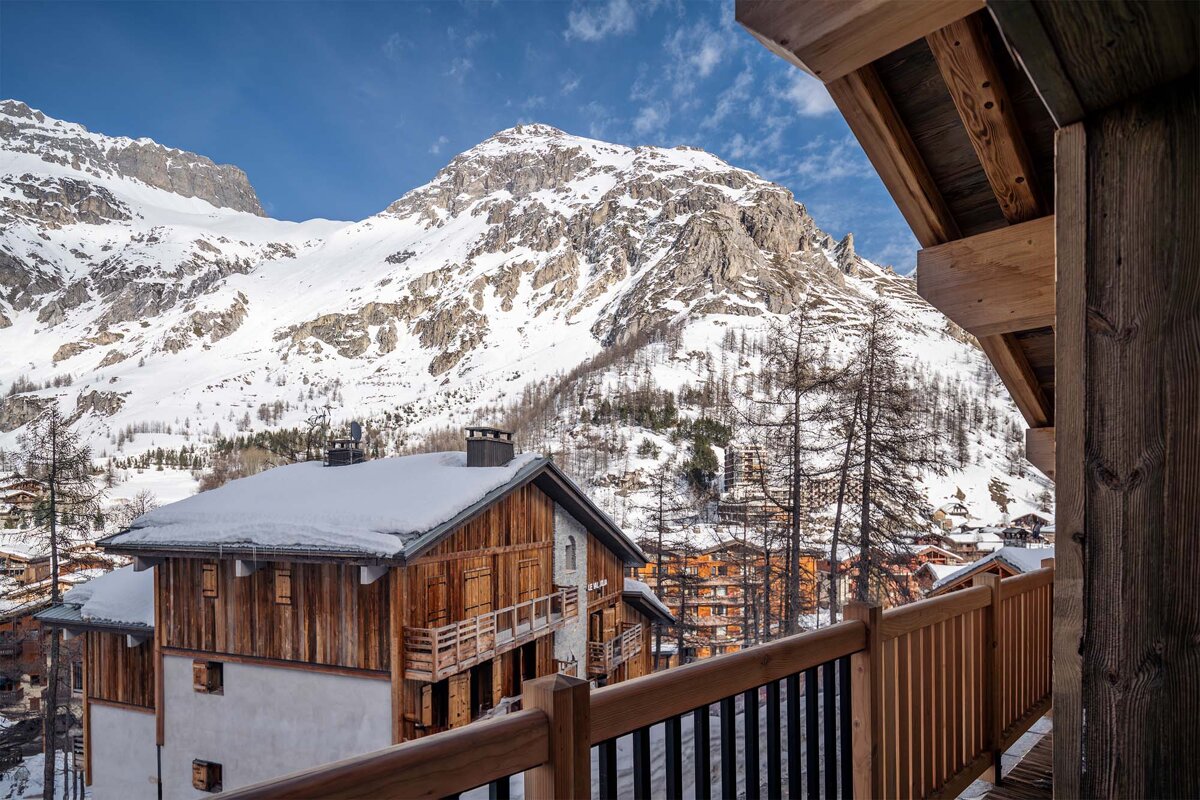 A view of a snowy mountain from a balcony