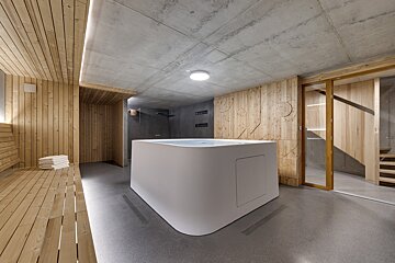 A white bathtub in a room with wooden walls