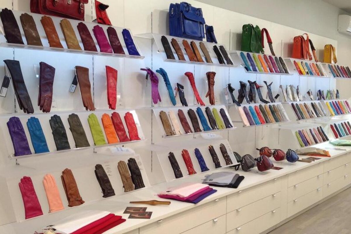 Many different colored gloves are on display in a store