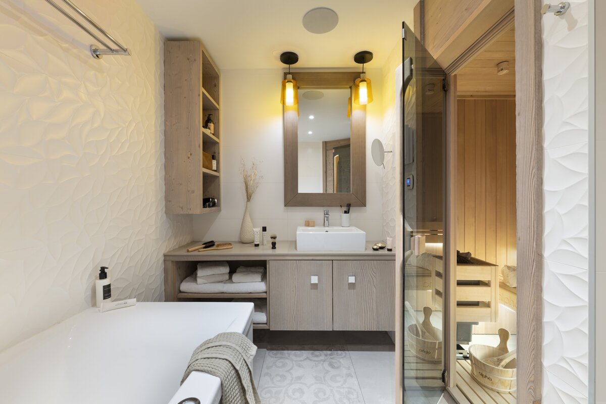A bathroom with a bathtub a sink and a sauna