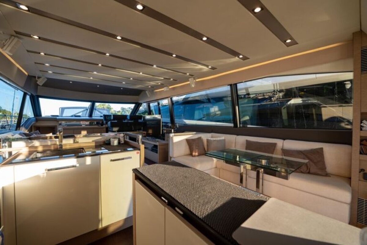 The inside of a boat with a couch and a table