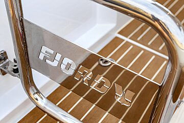 A stainless steel railing with the word fjord on it