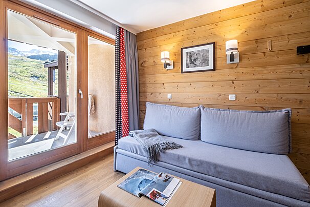 A living room with a couch and a magazine on a table