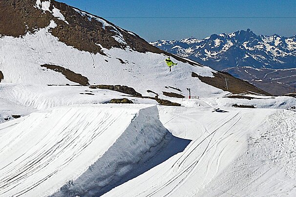 a freestyle skier jumping a big gap in the park