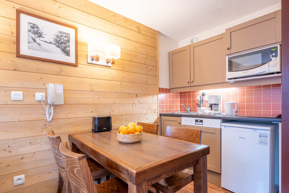 A small kitchen with a candy brand refrigerator