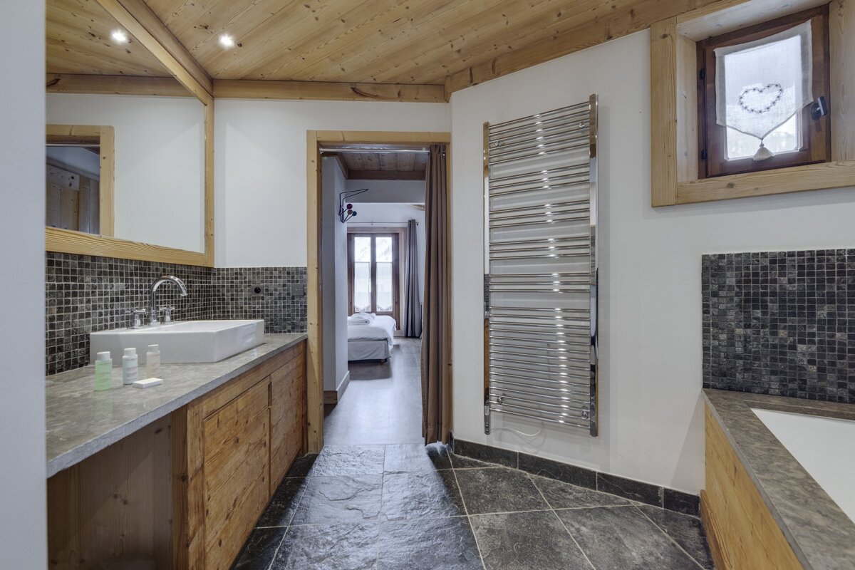 A bathroom with a sink and a towel rack