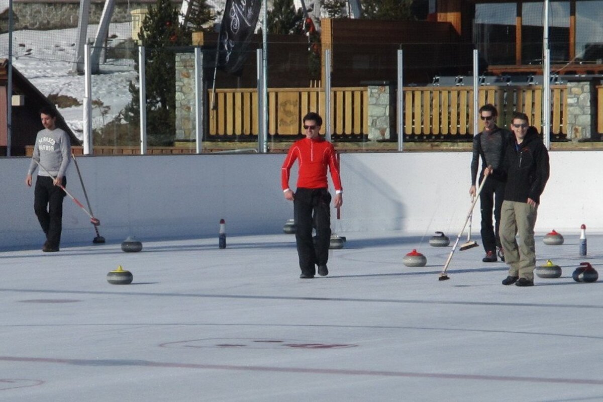 men playing curling on the ice