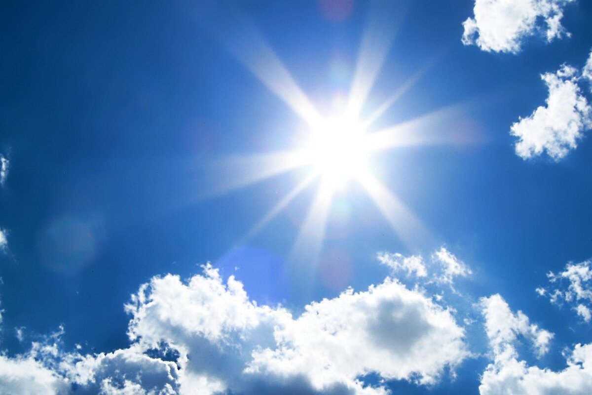 the sun beaming through the clouds