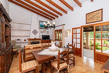 A living room with a table and chairs and a fireplace