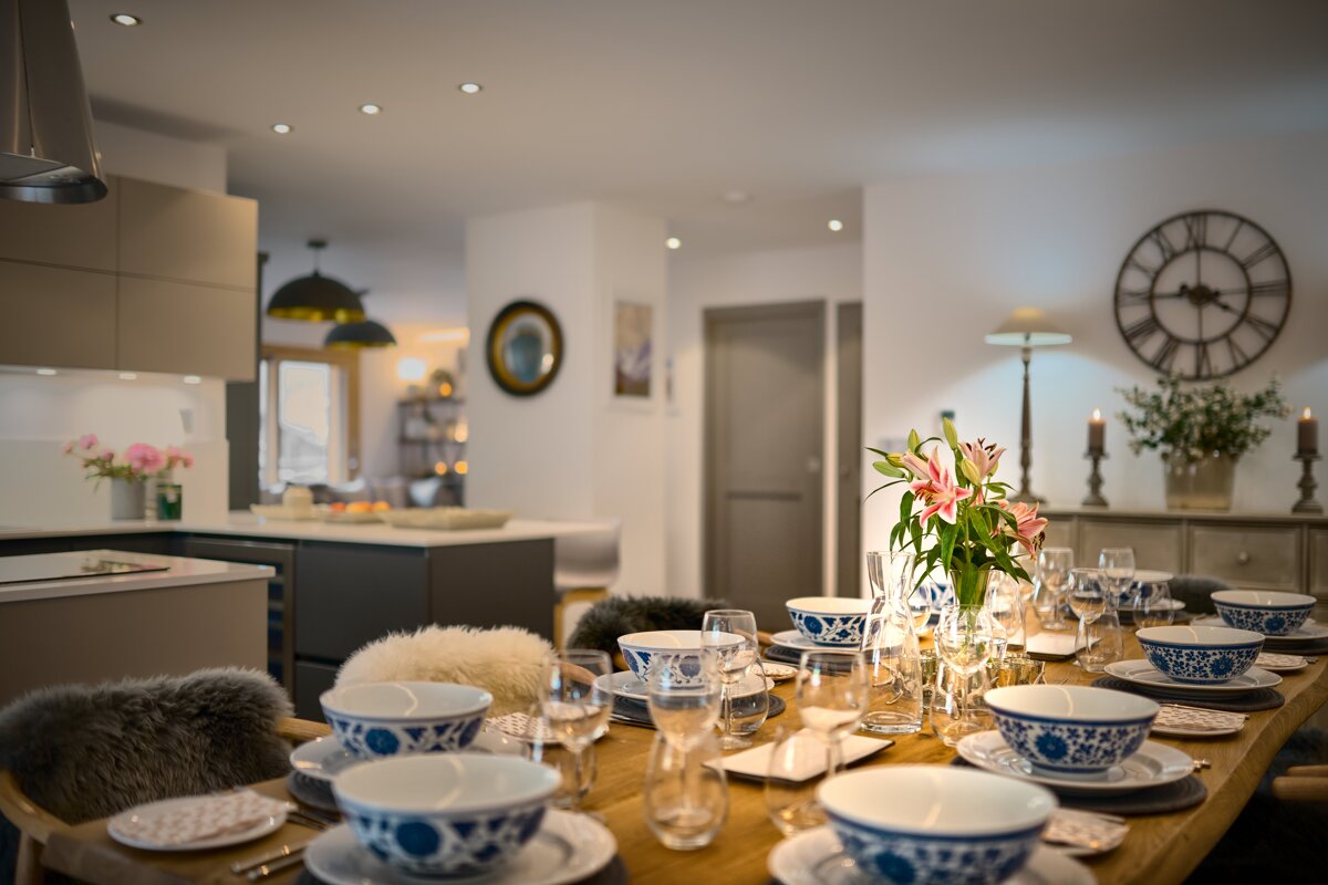 A table set for a meal with a vase of flowers on it