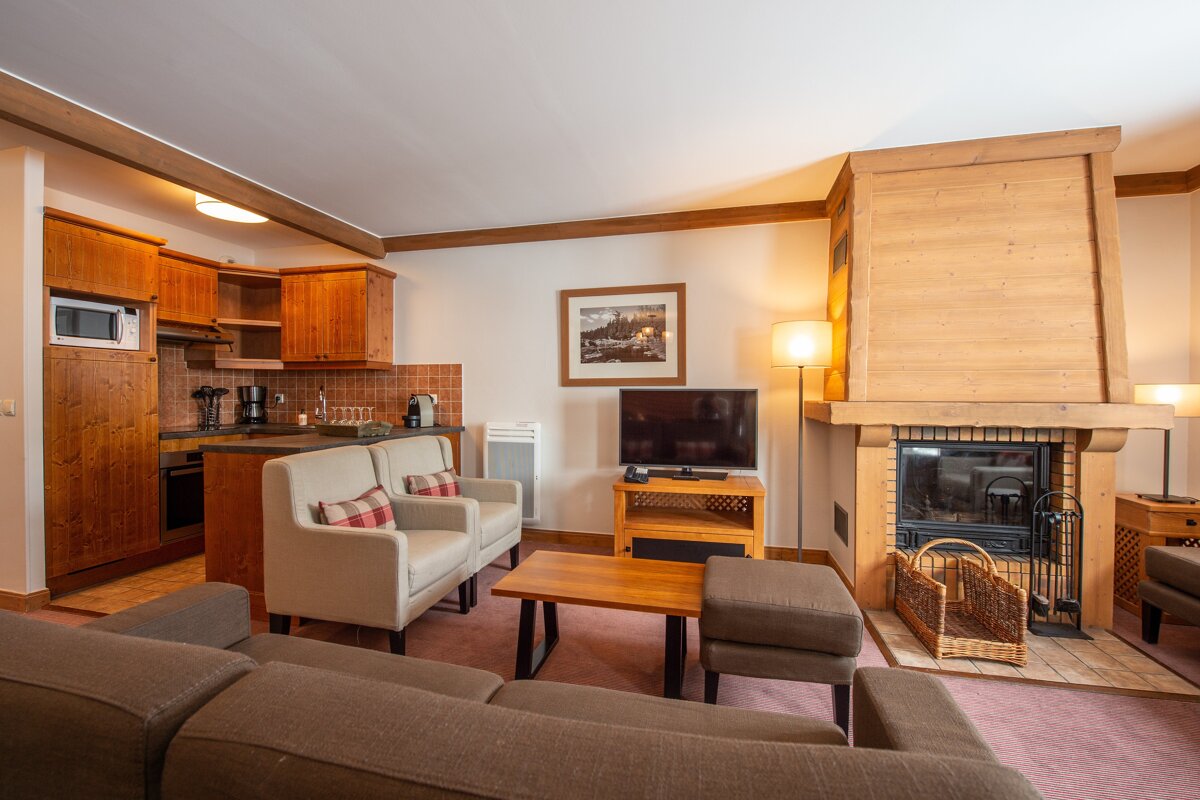 A living room with a fireplace and a flat screen tv