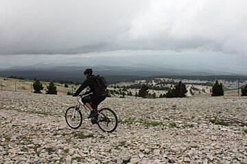 a mountain biker on a loose stone trail