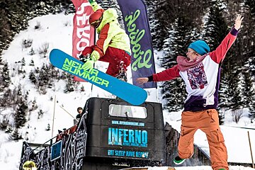 a snowboarder jumping through the air