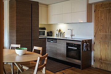 A kitchen with stainless steel appliances and wooden cabinets