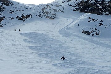three skiers off piste
