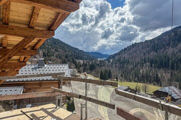 A view of a mountain valley from a balcony with a sign that says ' e91 ' on it