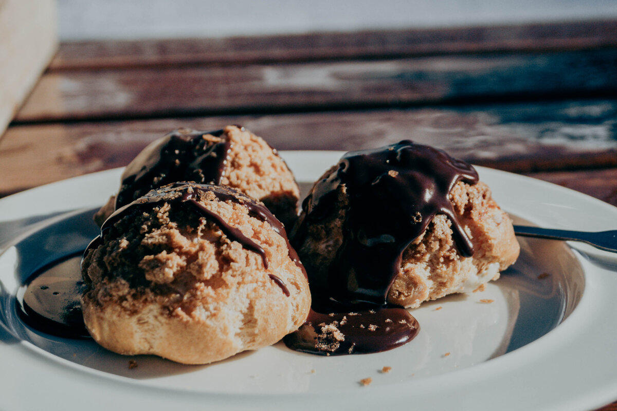 A white plate topped with ice cream and chocolate sauce