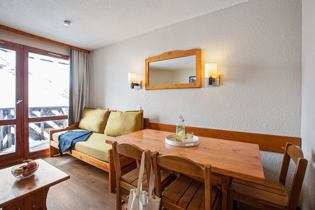 A living room with a couch and a table and chairs