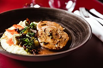 A plate of food with meat and mashed potatoes on a table