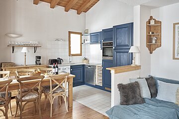 A kitchen with blue cabinets and stainless steel appliances