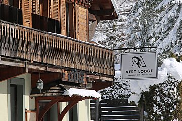 A sign for the vert lodge