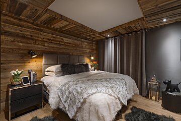 A bedroom with a bed and a nightstand