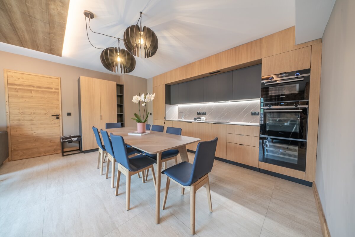 A kitchen with wooden cabinets and black appliances