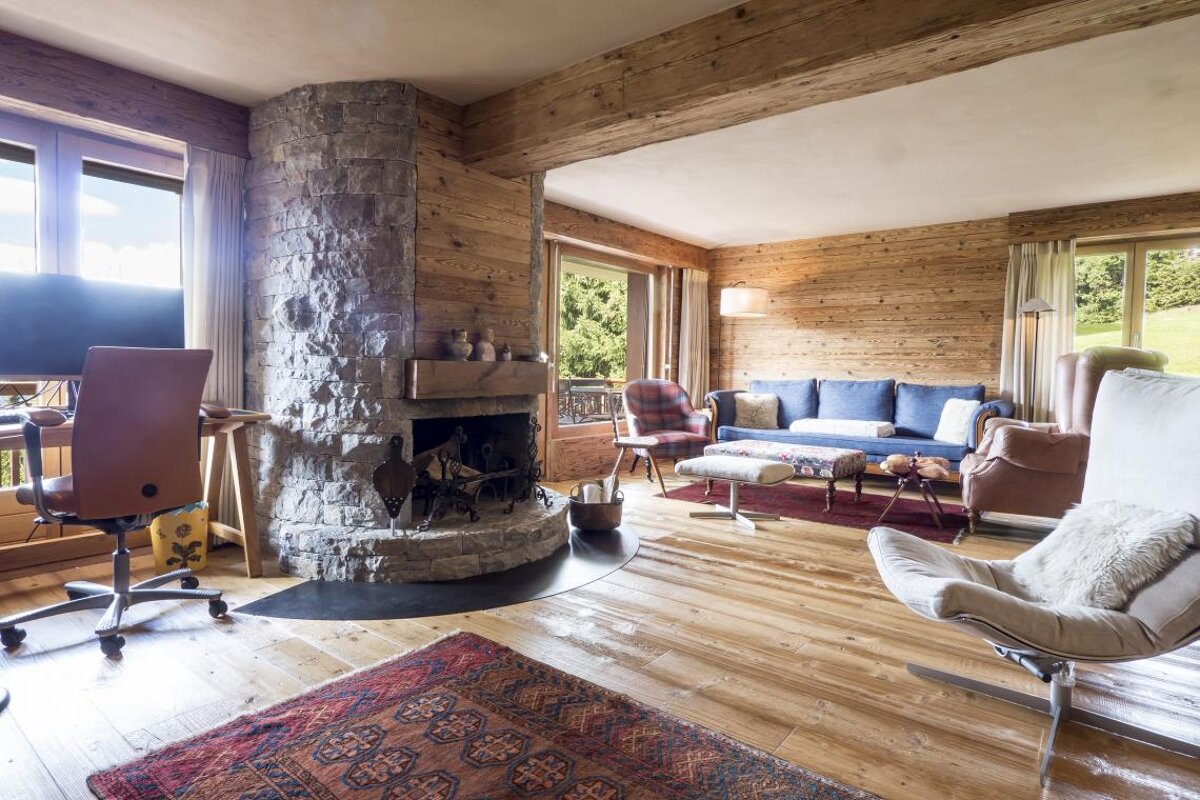 A living room with a stone fireplace and a couch