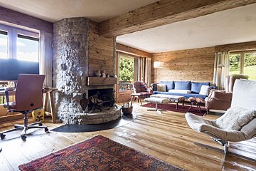 A living room with a stone fireplace and a couch