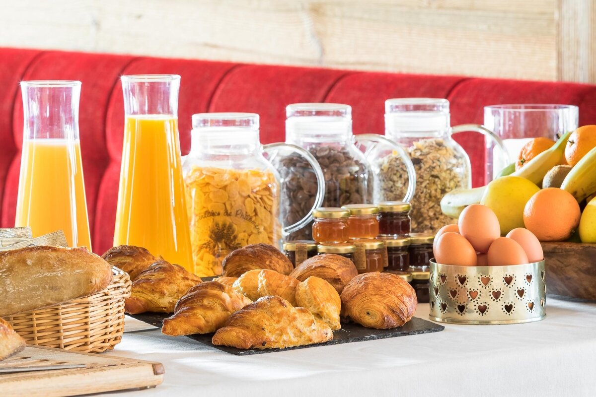 A table full of food including croissants and eggs