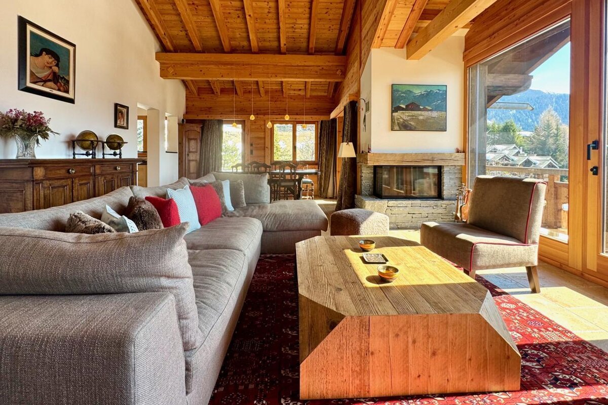 A living room with a large couch and a fireplace