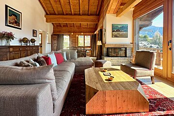 A living room with a large couch and a fireplace